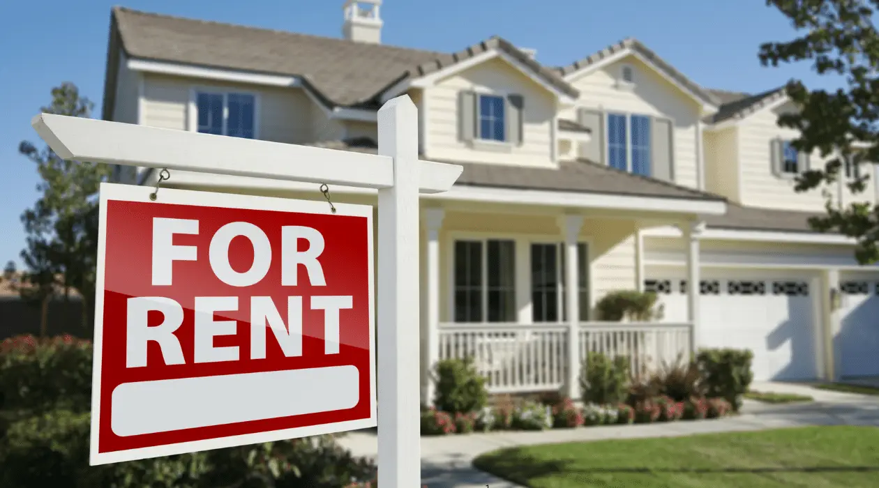 Photo of a For Rent sign on the lawn of a house